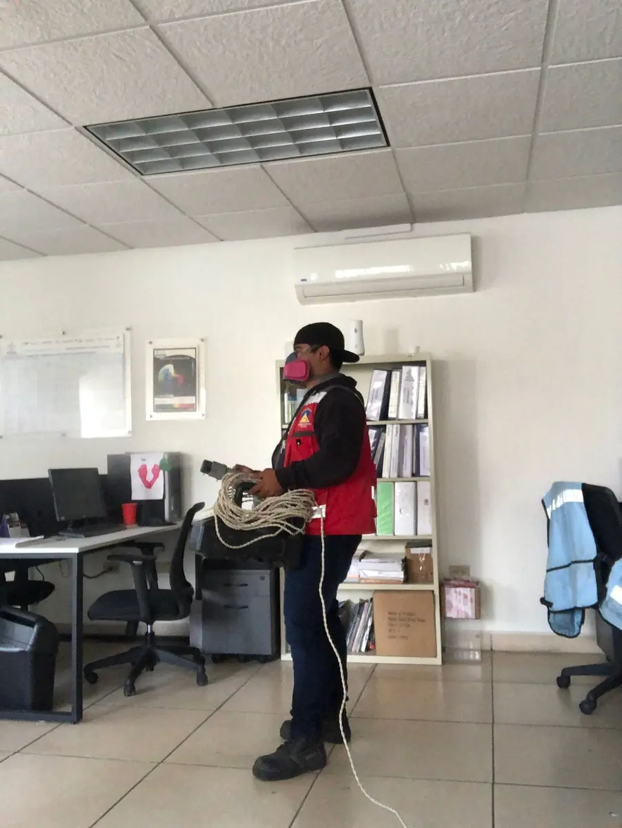 Técnico de EXPROPLAG realizando un servicio profesional en una oficina